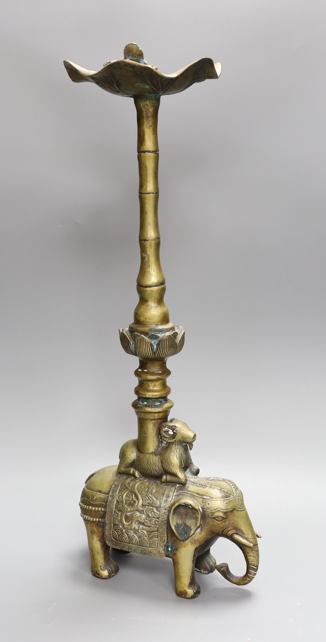 A Chinese bronze candle stand, 54 cms high